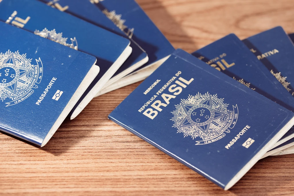 several Brazilian Passports on a wood table